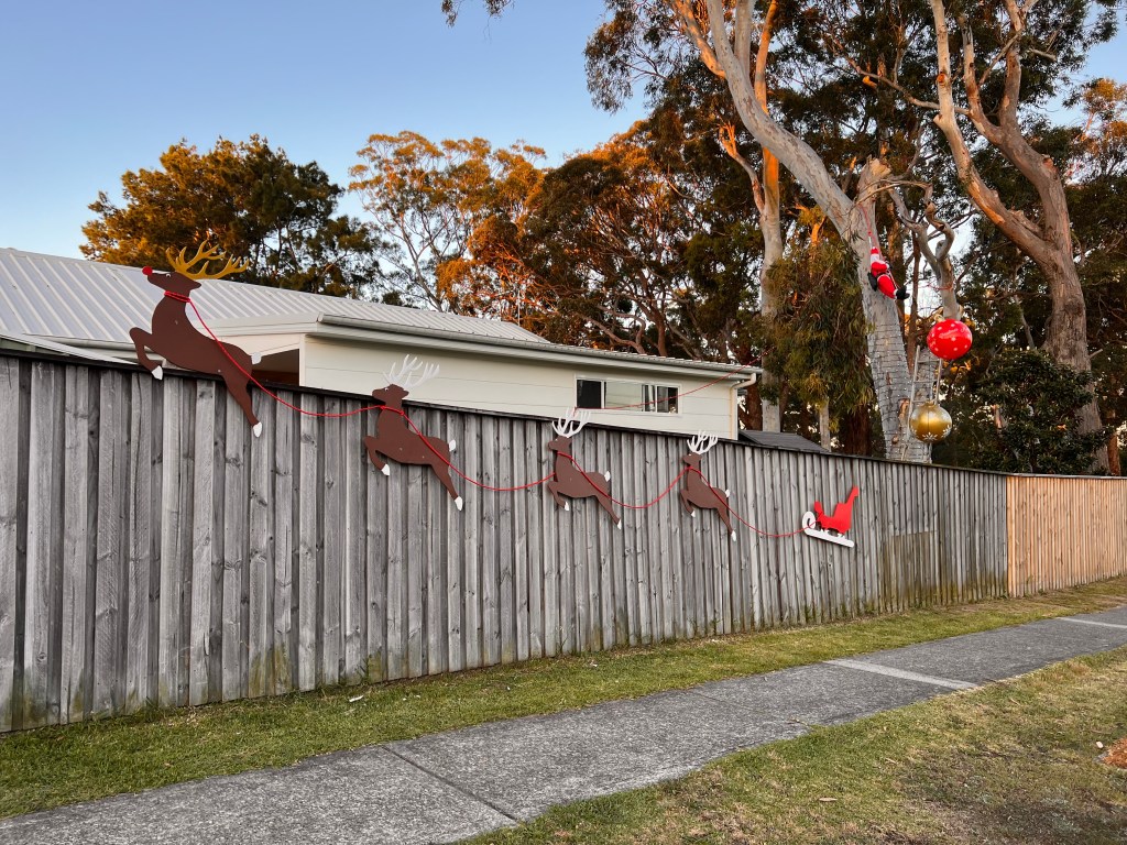 Christmas decorations on fence.